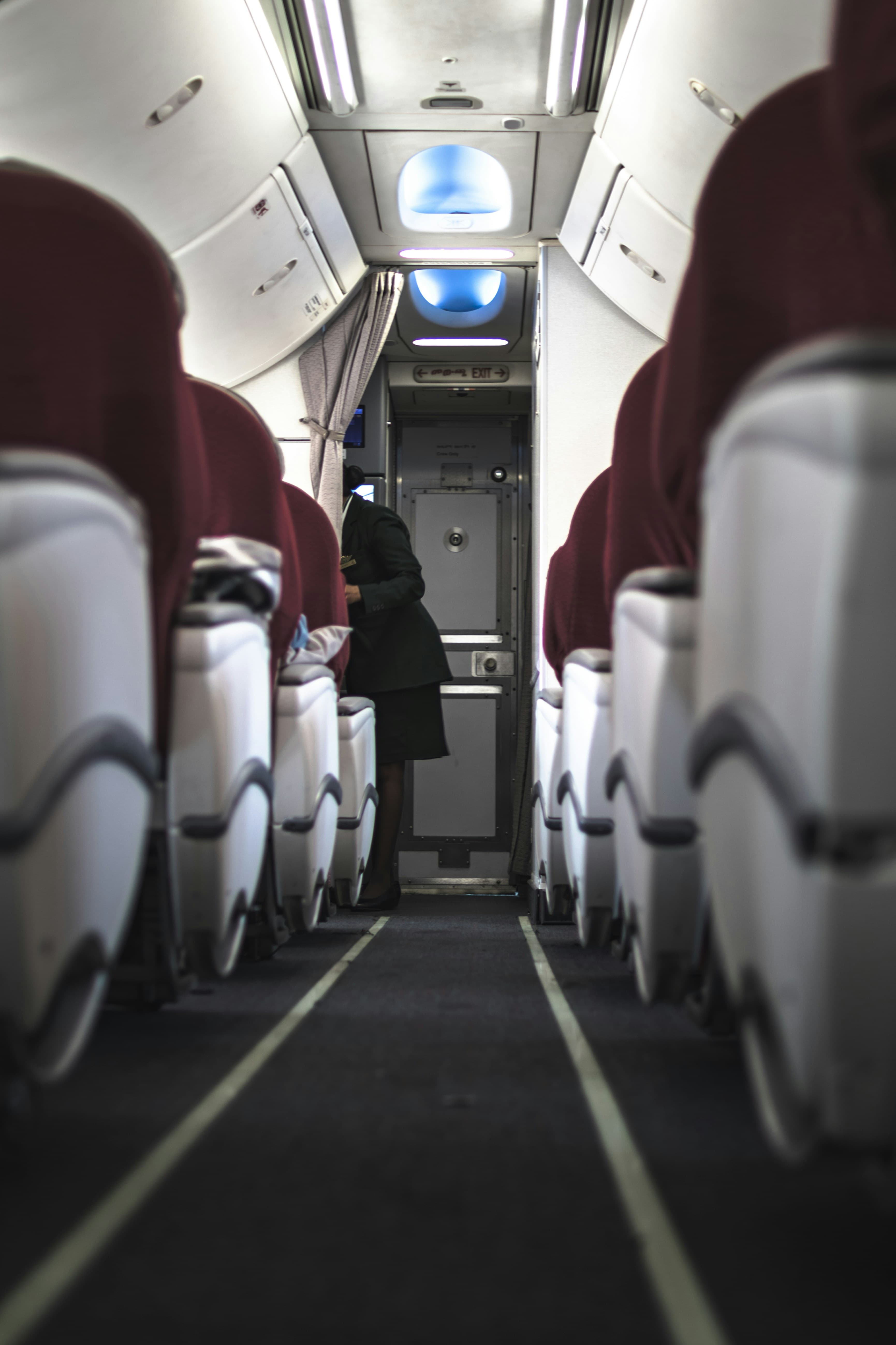 Cabin crew member working inside aircraft cabin