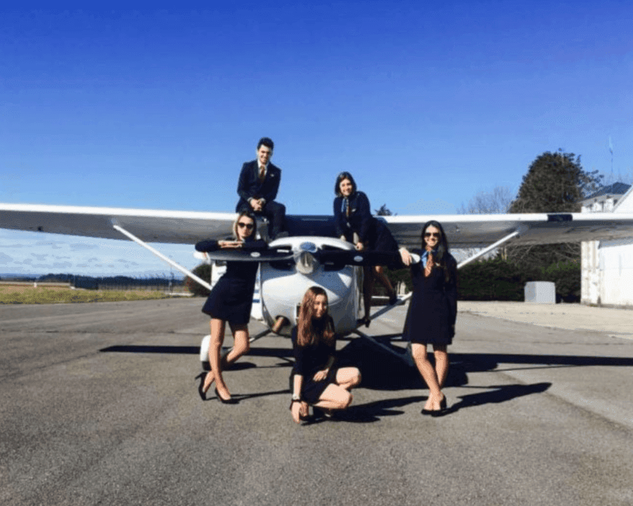 Profly Academy students posing with aircraft on tarmac